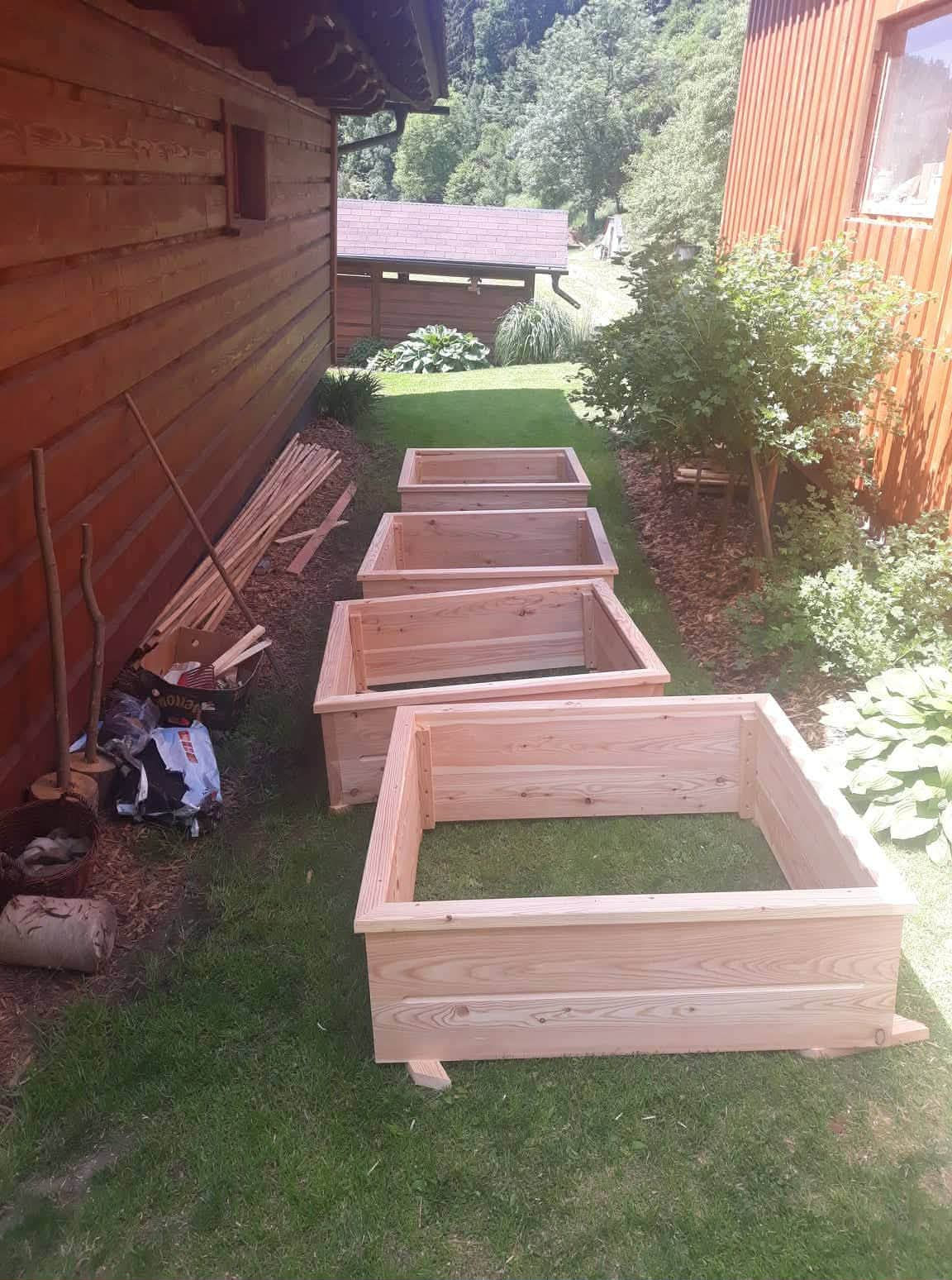 Řada vyvýšených záhonů na zahradě valašské chalupy